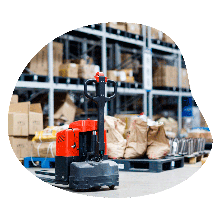 Warehouse shelves stacked with boxes, with a pallet jack in front