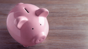 Pink piggy bank on a wooden table